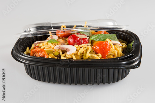 Chinese noodles in takeaway boxes with mushrooms