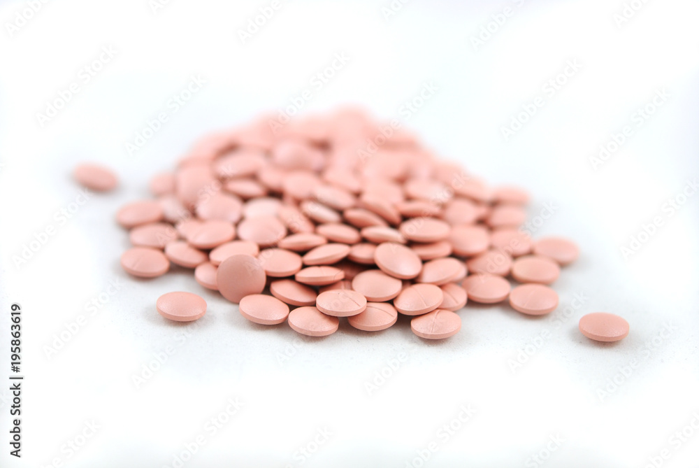 Rose round tablets close-up on white background Rose round tablets close-up on white background
