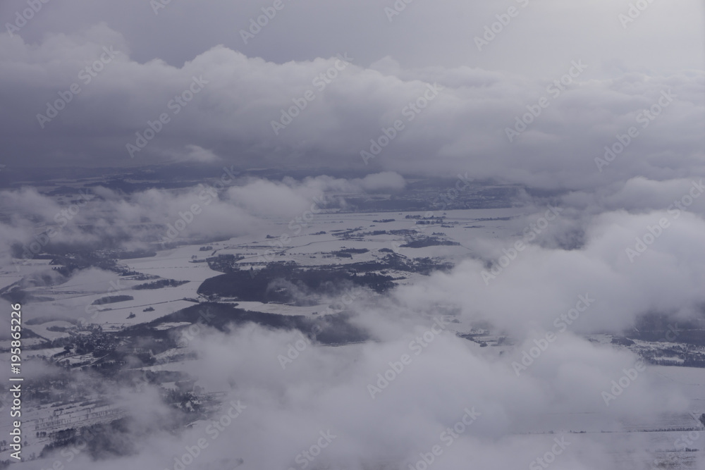Aerial view of city with clouds, winter-time