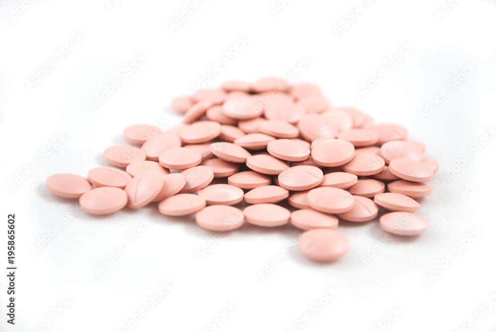 Light pink tablets closeup on white background Light pink tablets closeup on white background