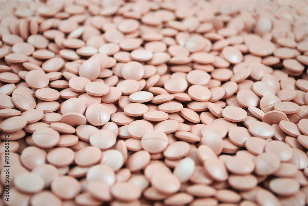 Light pink tablets closeup on white background Light pink tablets closeup on white background