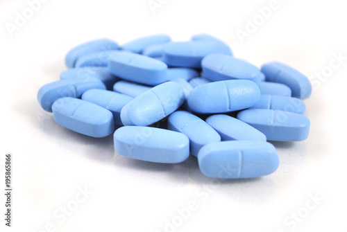 Big oval blue tablets closeup on white background