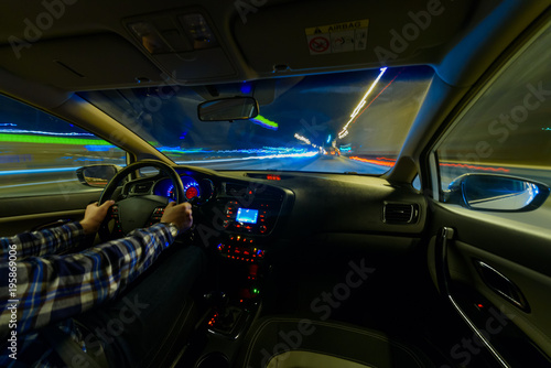 Driving in night scenery, hands on steering wheel, night rain time © narozhnii