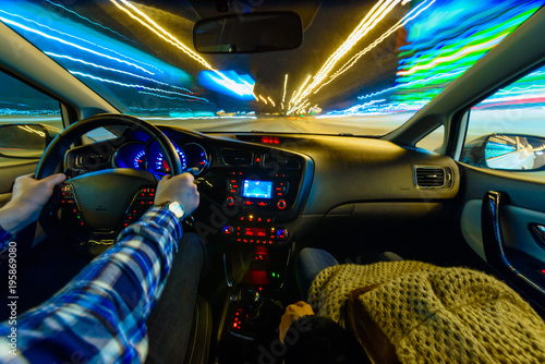 Driving in night scenery, hands on steering wheel, night rain time