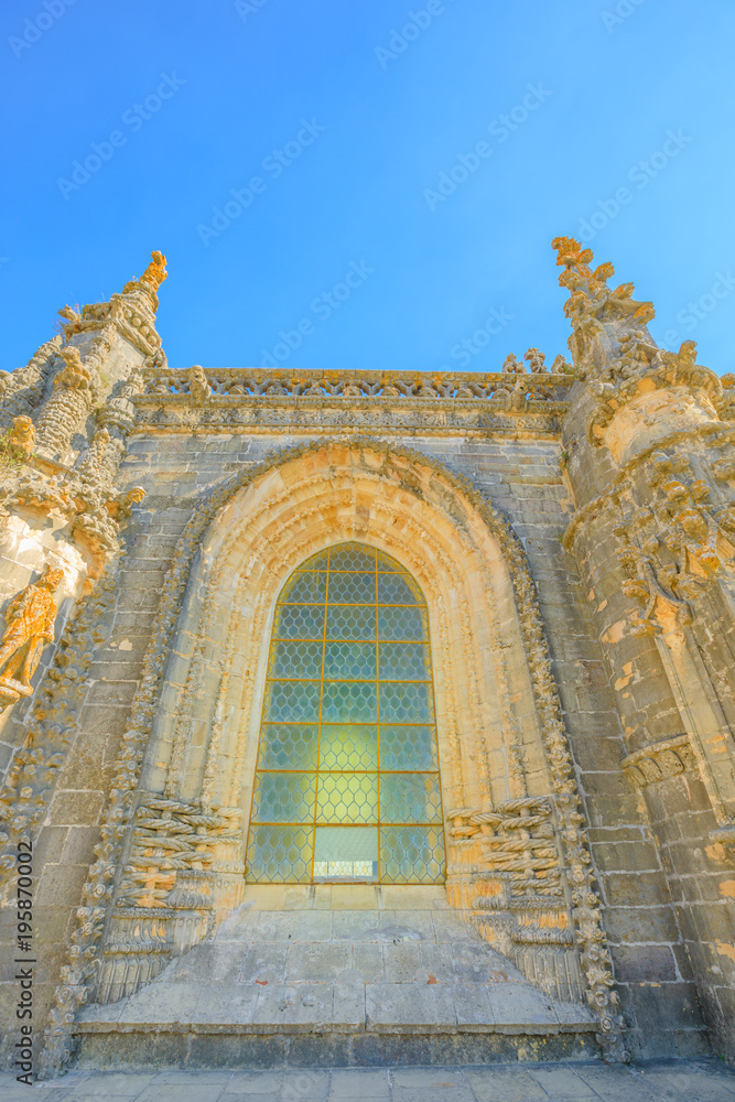Elements of architecture in Portugal. Details of glass window of Convent of Christ or Convento dos Cavaleiros de Cristo, in Tomar, Portugal. Sunny day, blue sky. Manueline style.