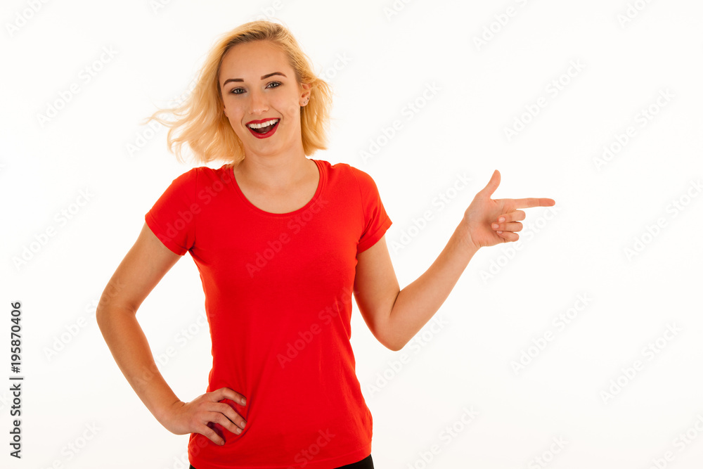 Attractive beautiful young blonde woman pointing into copyspace when advertising a product Attractive beautiful young blonde woman pointing into copyspace when advertising a product