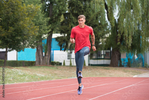 Young Male Athlete Running on Track