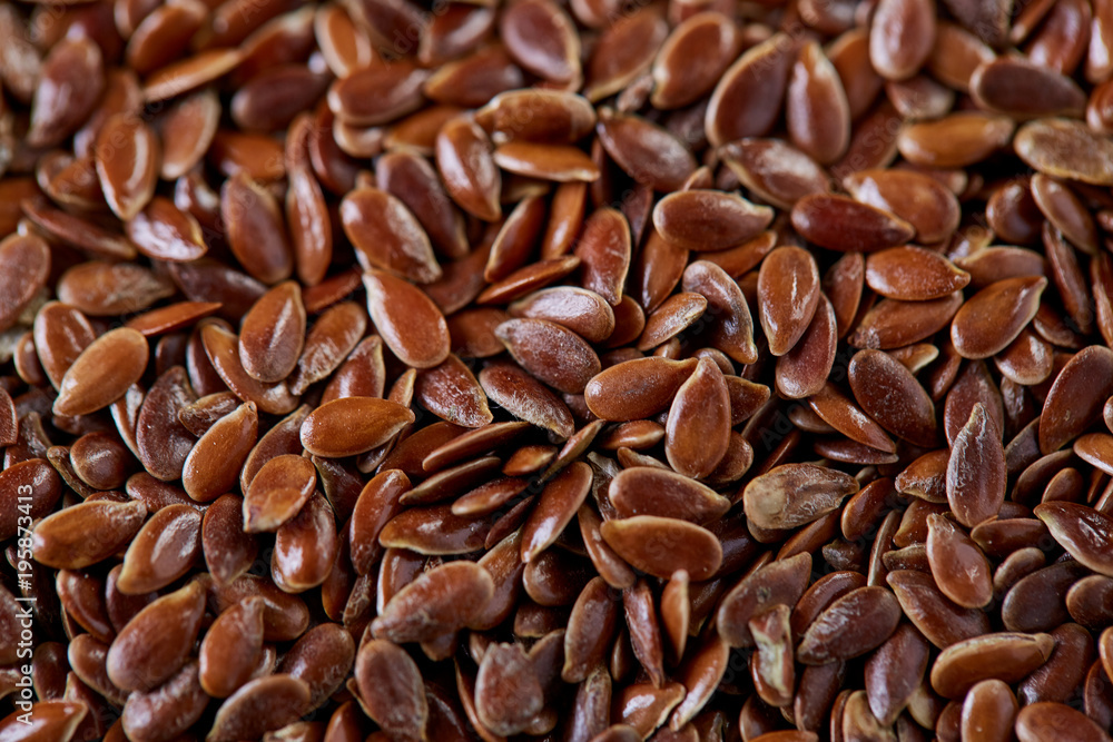Top view close-up picture of separate flax seed on light textured background, macro, selective focus. Top view close-up picture of separate flax seed on light textured background, macro, selective focus.