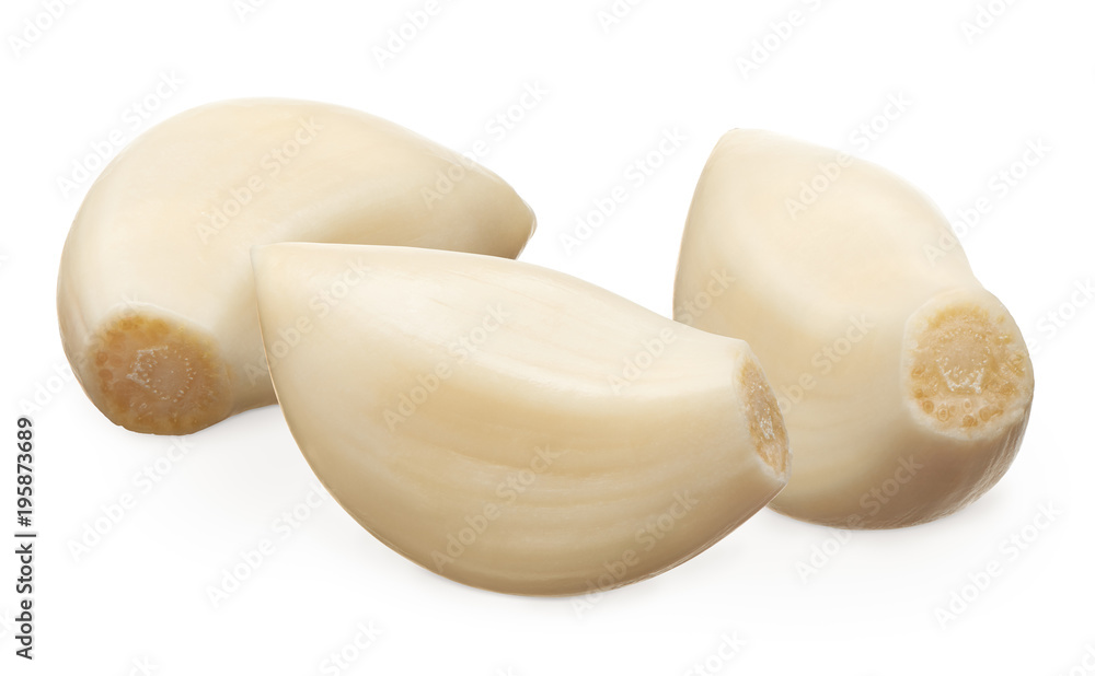 Three peeled cloves of garlic isolated on white