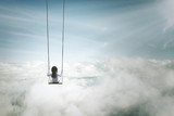 Lonely girl sitting on the swing above clouds