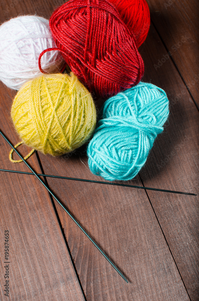 Knitting. Cloth strings on a wooden background. The concept of k