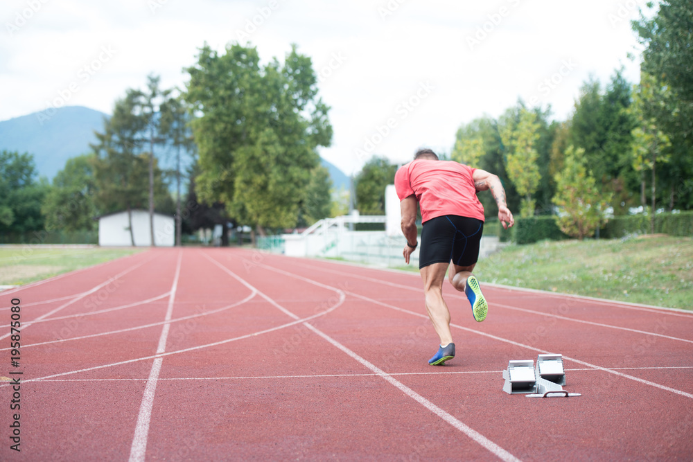 Sprinter Leaving Starting Blocks on the Running Track