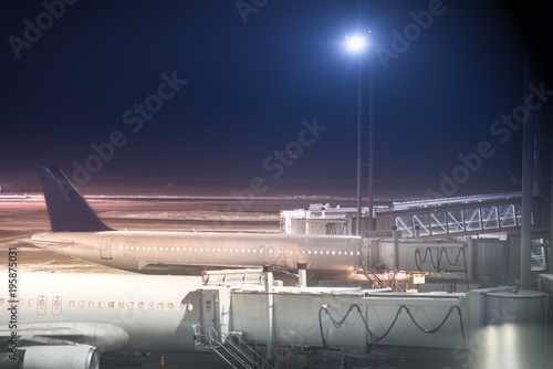 Parked aircrafts on an international airport through the gate windows