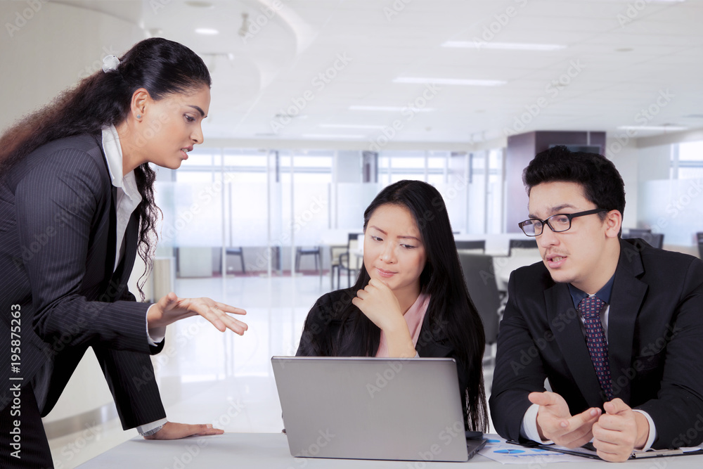 Indian business manager talking to her team in a meeting Indian business manager talking to her team in a meeting