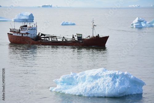 lonely red fishing boat in the disko bay - Greenland Ilulissat - ocean with icebergs - nautical vessel, marina