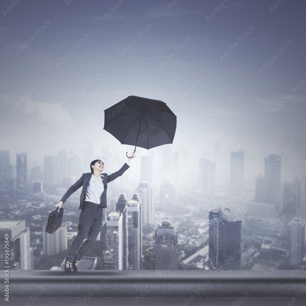 Beautiful manager with umbrella on rooftop Beautiful manager with umbrella on rooftop