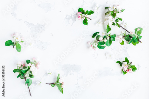 Flowers composition. Frame made of apple tree flowers on white background. Flat lay, top view, copy space
