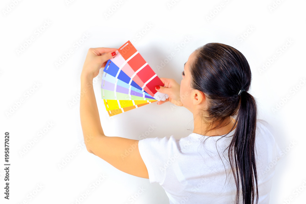 girl painter chooses the color of paint to repair the room girl painter chooses the color of paint to repair the room