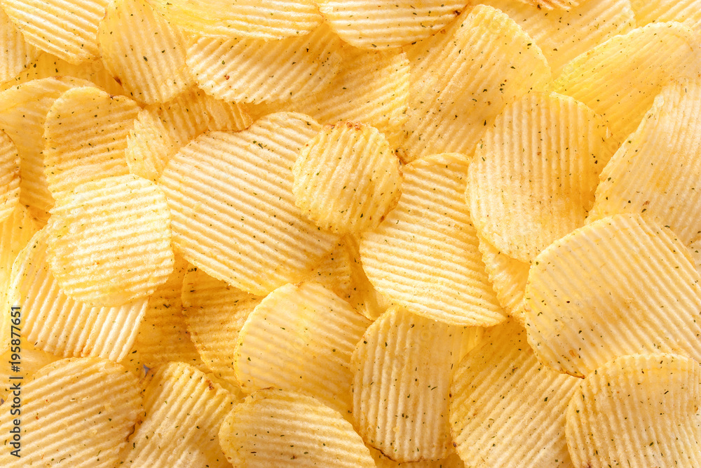 Potato chips background in the sunlight. Closeup. Potato chips background in the sunlight. Closeup.