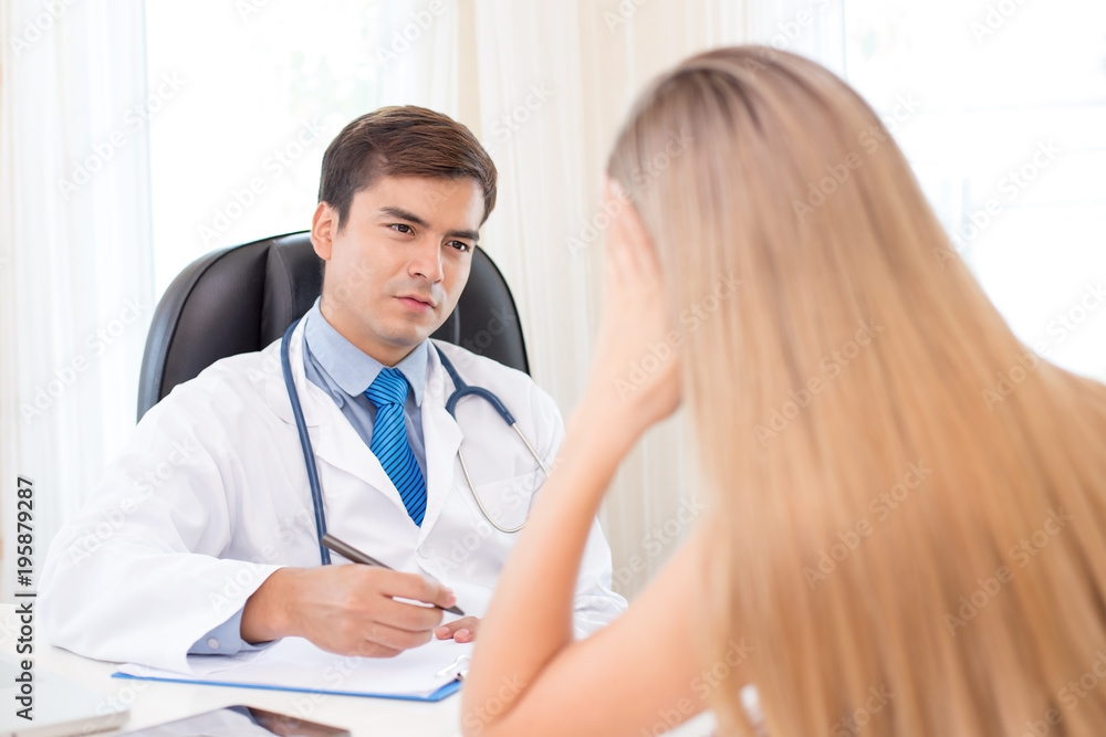 Attractive male doctor talking to patient at clinic. Medical and Health care concept. Attractive male doctor talking to patient at clinic. Medical and Health care concept.