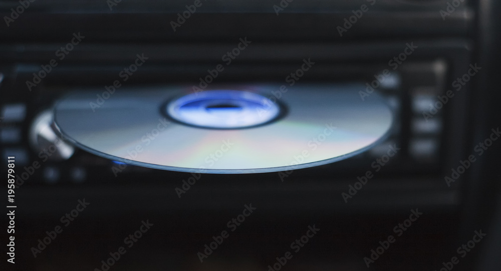 Obraz premium Audio CD in the car stereo. Music on the road