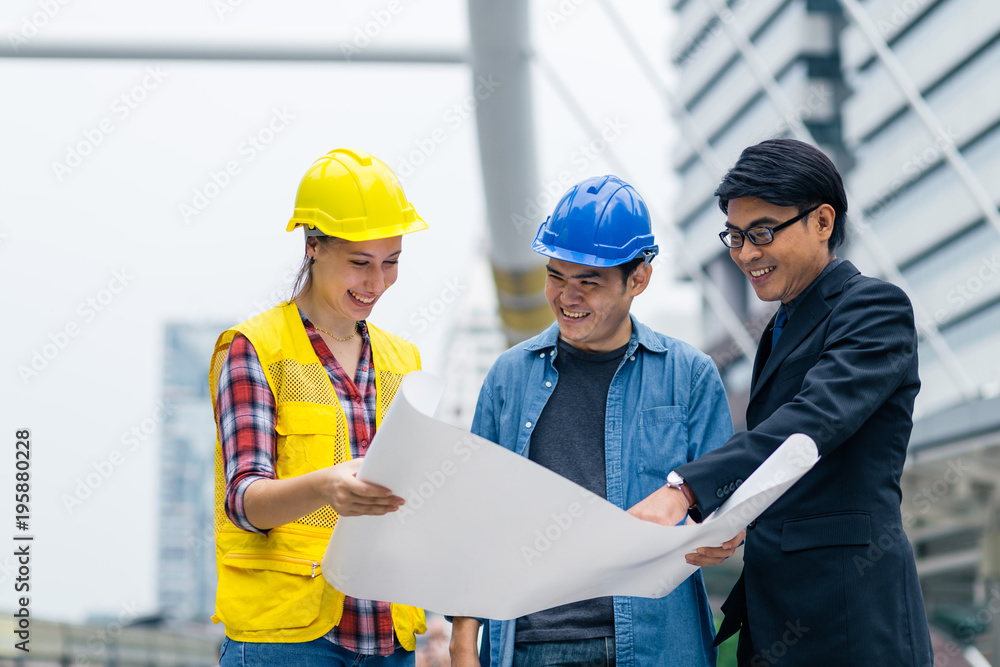 Meeting of engineer team and manager with construction on background Meeting of engineer team and manager with construction on background