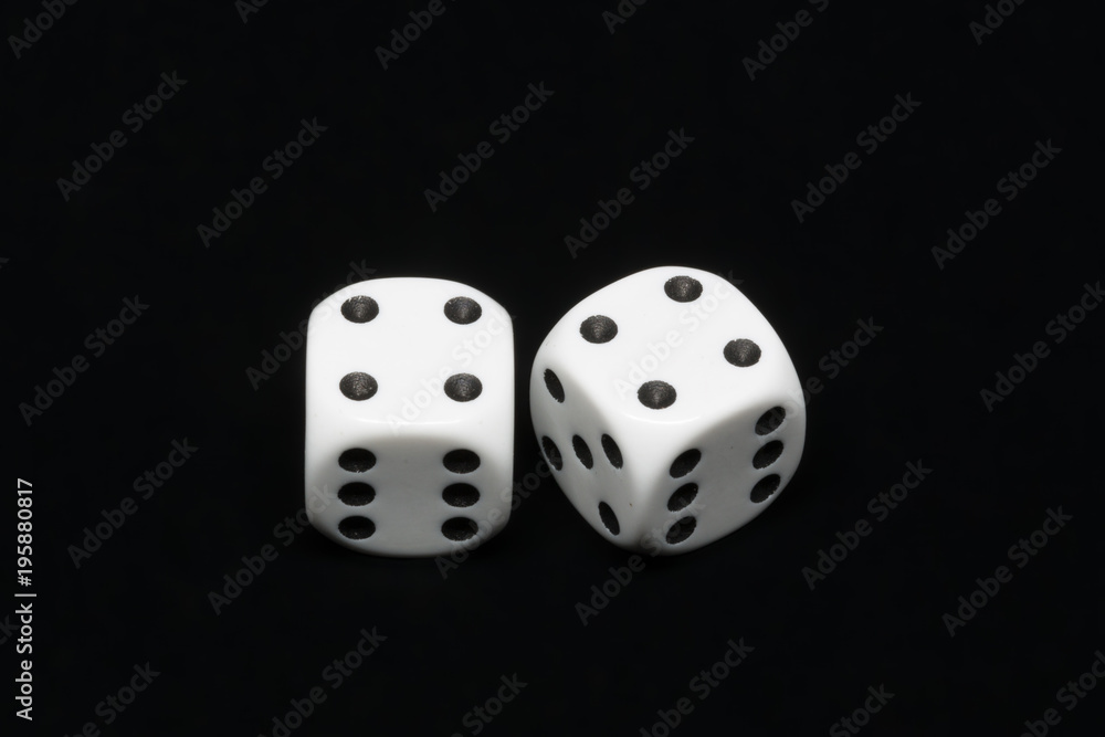 The dices are cast - two dices on a black background showing a total of eight eyes 