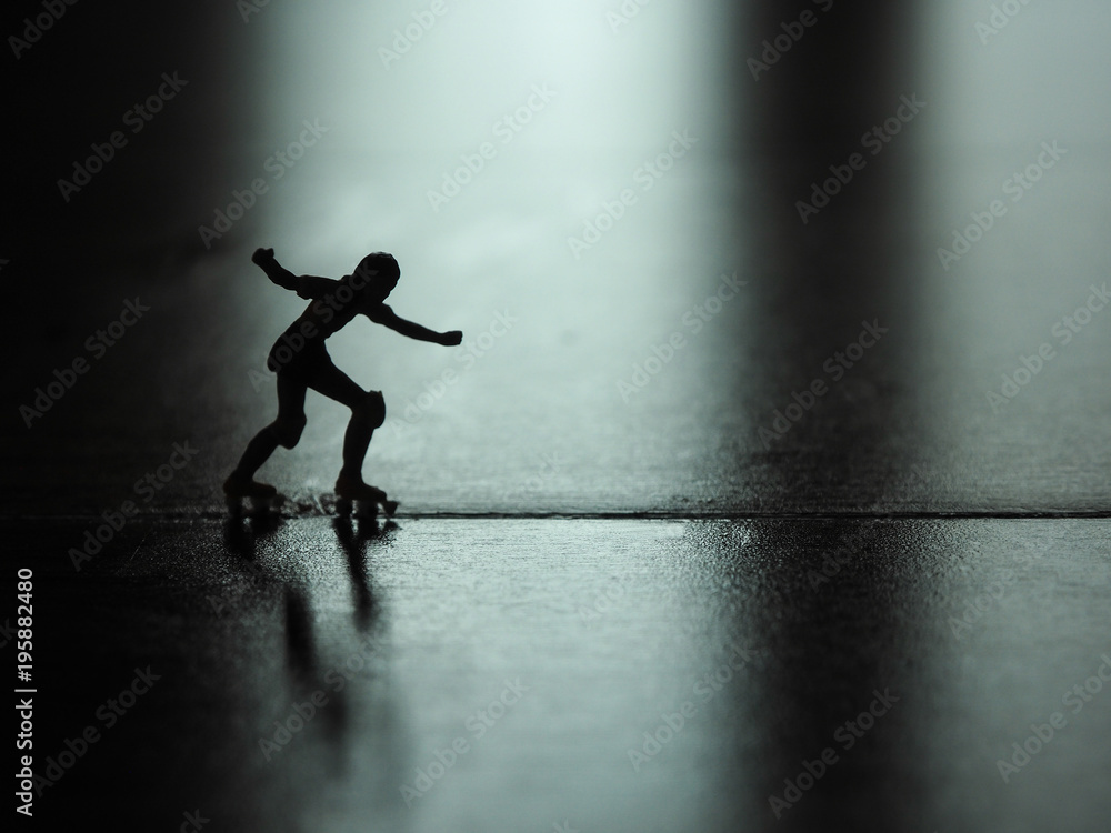 Silhouette miniature woman skating on the floor. Silhouette miniature woman skating on the floor.