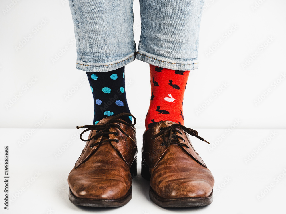 Male legs in bright, colorful socks and stylish, vintage shoes on a white background. Lifestyle, fashion, fun - obrazy, fototapety, plakaty 