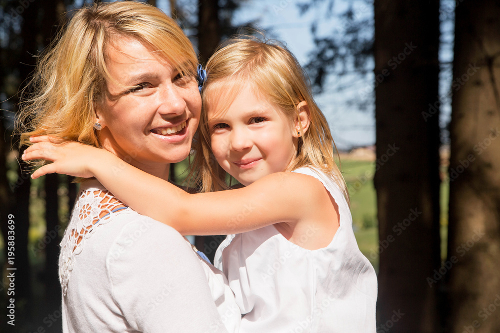 happy mother and daughter on a walk in the forest. Portrait happy mother and daughter on a walk in the forest. Portrait
