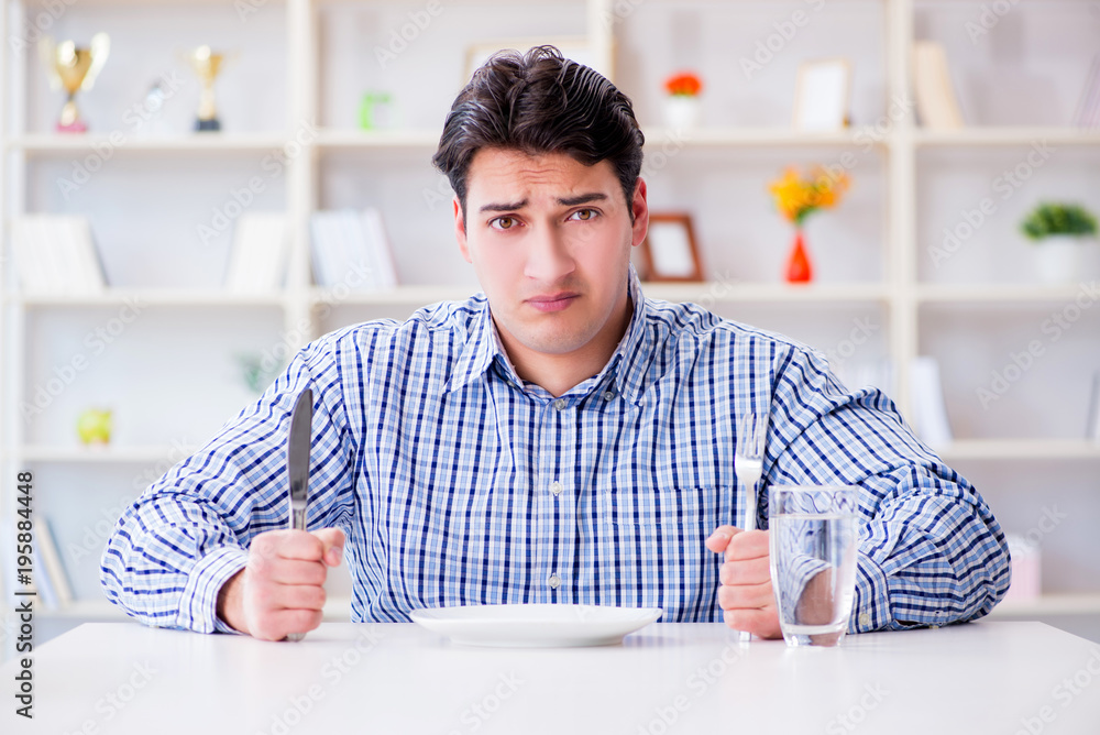 Man on diet waiting for food in restaurant Man on diet waiting for food in restaurant