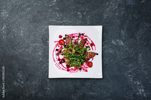 Foie gras salad with wild berry sauce. photo