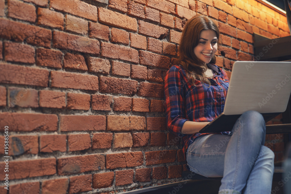 Smiling girl with laptop indoors Smiling girl with laptop indoors