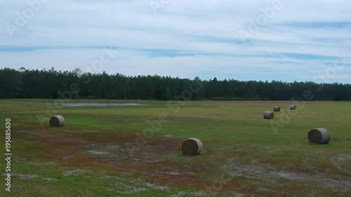 Ariel pan of hay field and lake in Florida
