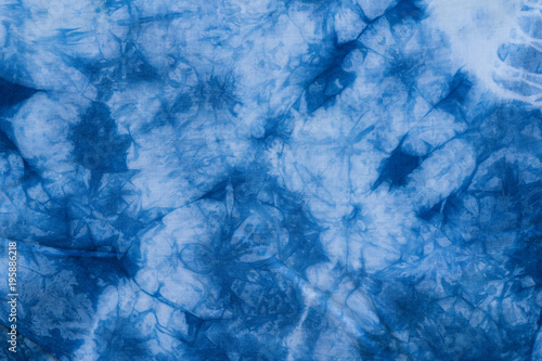 Pattern of blue tie batik dye on cotton cloth, Dyed indigo fabric background and textured photo