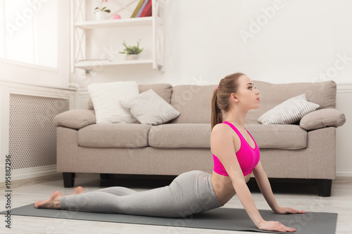 Woman training yoga in cobra pose.