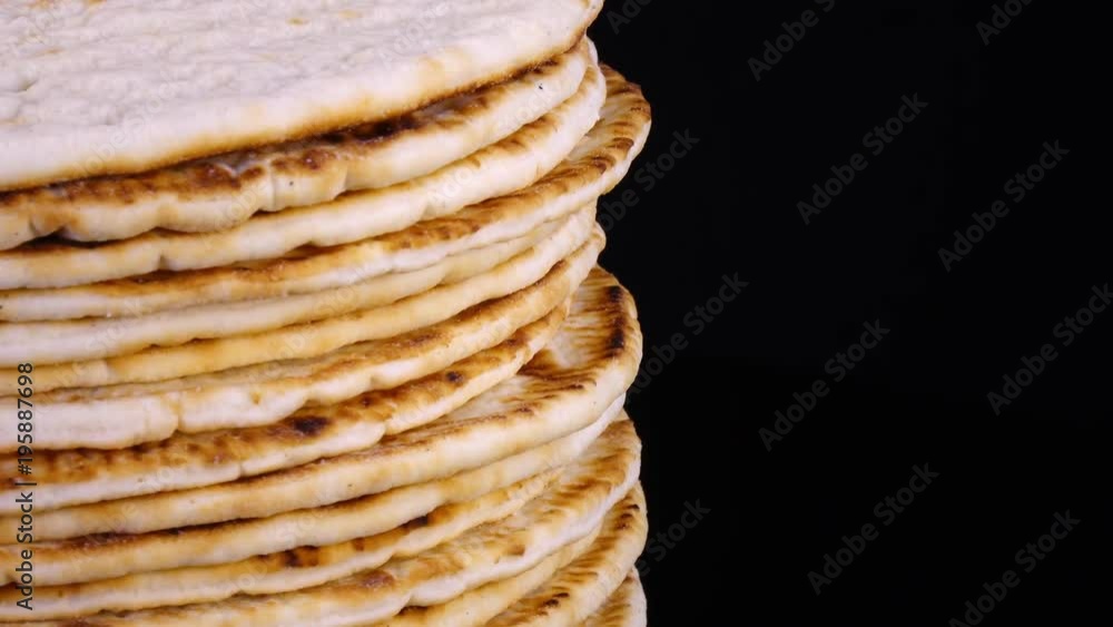 Traditional tasty flat bread (lavash, pita, chapati, scone) rotating on black background in 4K. Closeup view of food texture with free space for text.
Traditional tasty flat bread (lavash, pita, chapati, scone) rotating on black background in 4K. Closeup view of food texture with free space for text.
