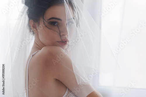 Pretty shy bride with a veil close-up portrait. Morning before wedding © oksana_bondar