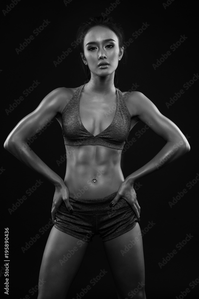 Sporty young girl in sportswear exercising black and white Sporty young girl in sportswear exercising black and white