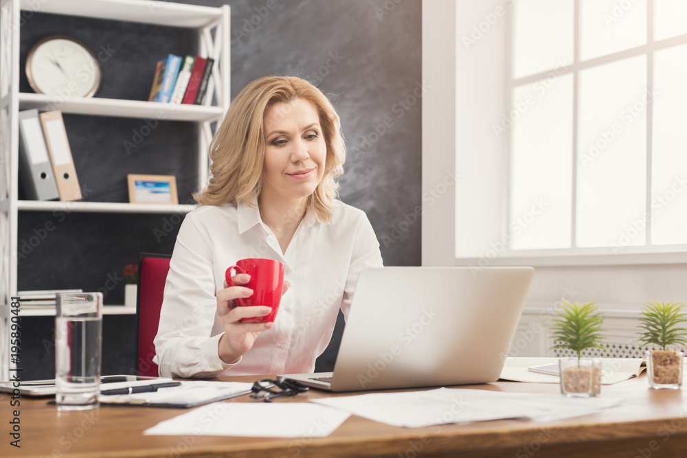 Businesswoman working on laptop at office Businesswoman working on laptop at office