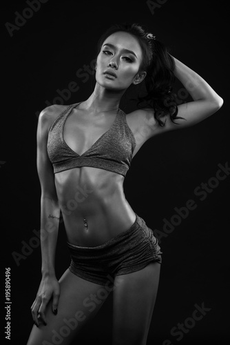 Sporty young girl in sportswear exercising black and white © lopwanchana