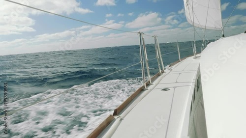 View of waves and sky from board of sailing yacht