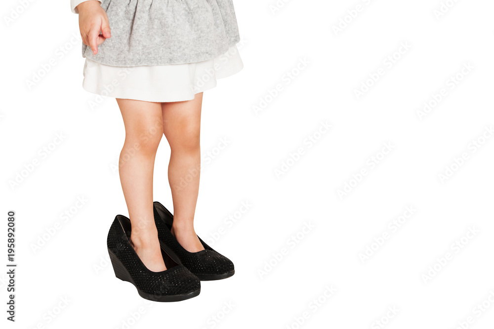 Little baby girl wearing big shoes. Isolated on white background. Little baby girl wearing big shoes. Isolated on white background.