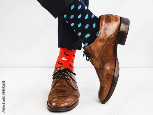 Office Manager in stylish shoes, blue pants and bright, colorful socks on a white background. Lifestyle, fashion, fun photo