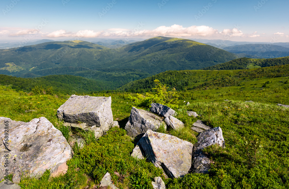 beautiful mountain landscape on summer morning. boulders among the grass on hillside beautiful mountain landscape on summer morning. boulders among the grass on hillside