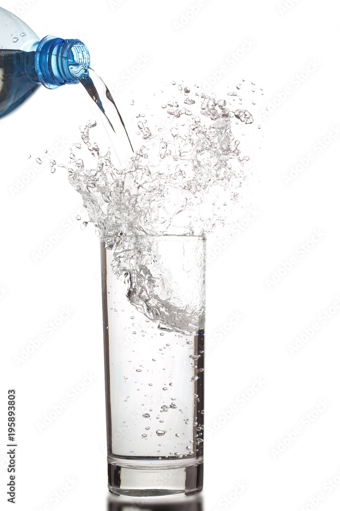 Pouring water into glass isolated on white Pouring water into glass isolated on white
