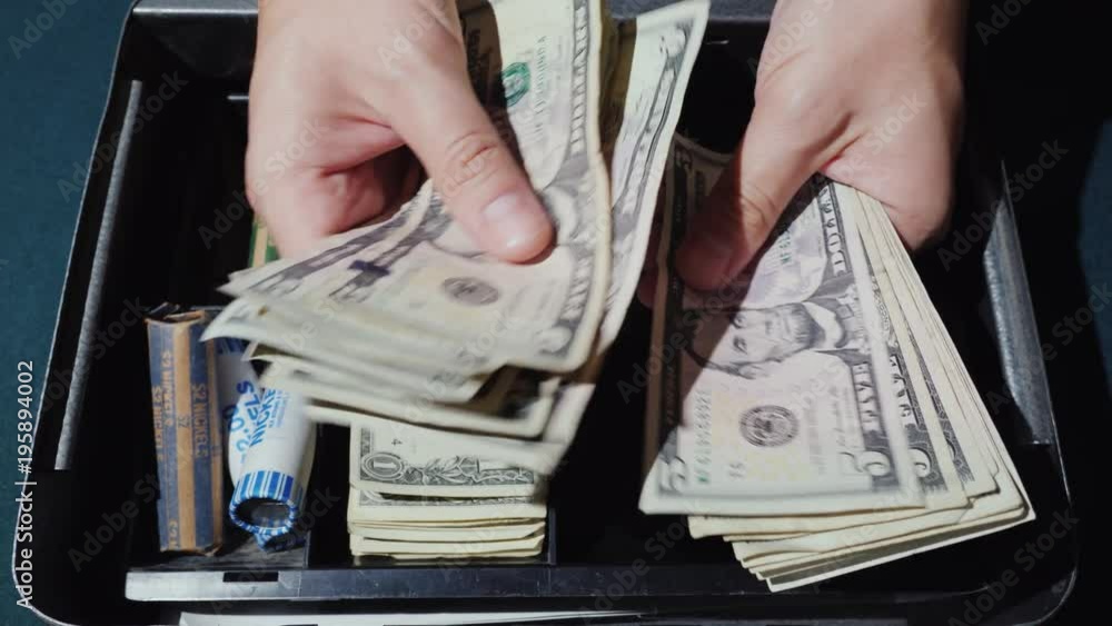 A man counts the money in a cash box. Outbound trade and good revenue concept