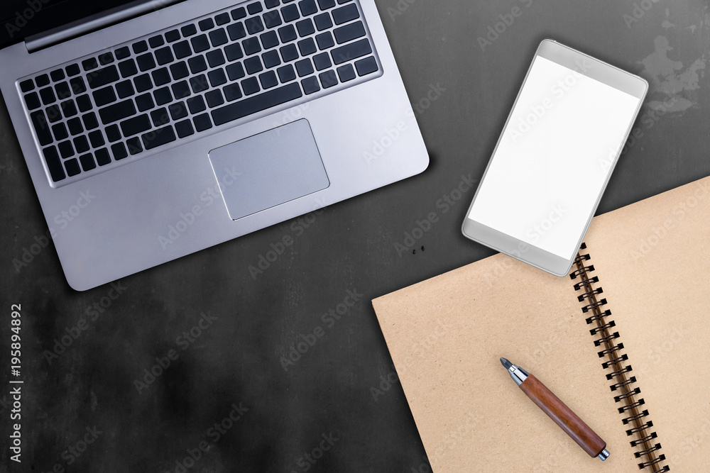 laptop smartphone notebook and wooden pencil stationary on black concrete table background with free copy space for your text laptop smartphone notebook and wooden pencil stationary on black concrete table background with free copy space for your text