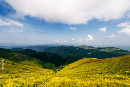 Dramatic sky over mountains in summer. Reach the top of the hill. Travel in wild terrain. Alpine highland. Stormy clouds. Camping trip in touristic route. Picturesque beautiful nature landscape. photo