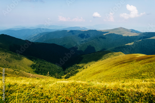 Dramatic sky over mountains in summer. Reach the top of the hill. Travel in wild terrain. Alpine highland. Stormy clouds. Camping trip in touristic route. Picturesque beautiful nature landscape.